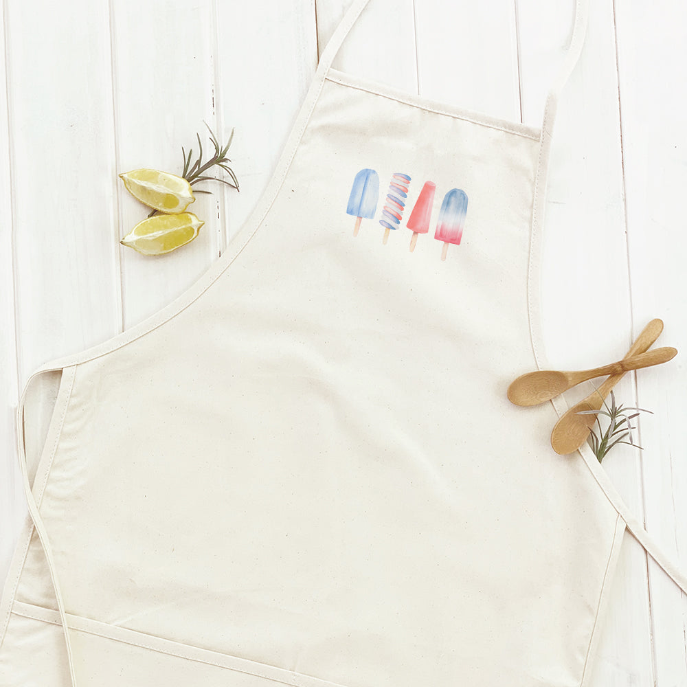 Patriotic Popsicles Women's Apron featuring a vibrant design, adjustable neck strap, and divided front pocket, made from durable cotton canvas.