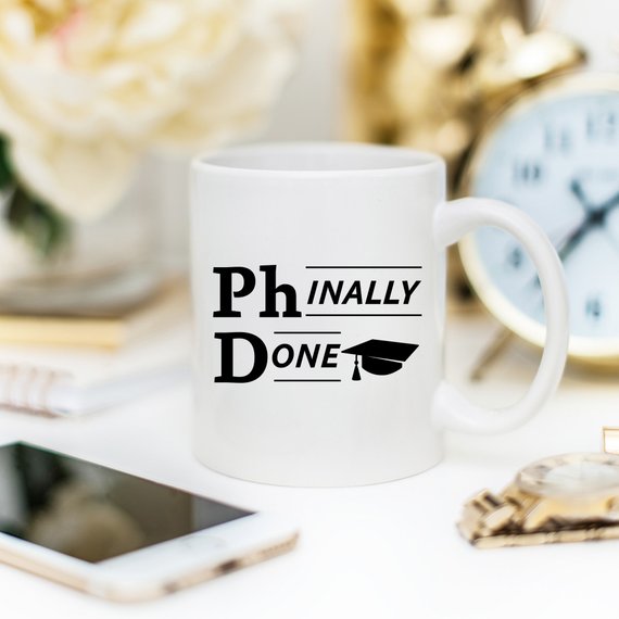 Phinally Done Funny Coffee Mug featuring a humorous design for PhD graduates, made of high-quality ceramic.