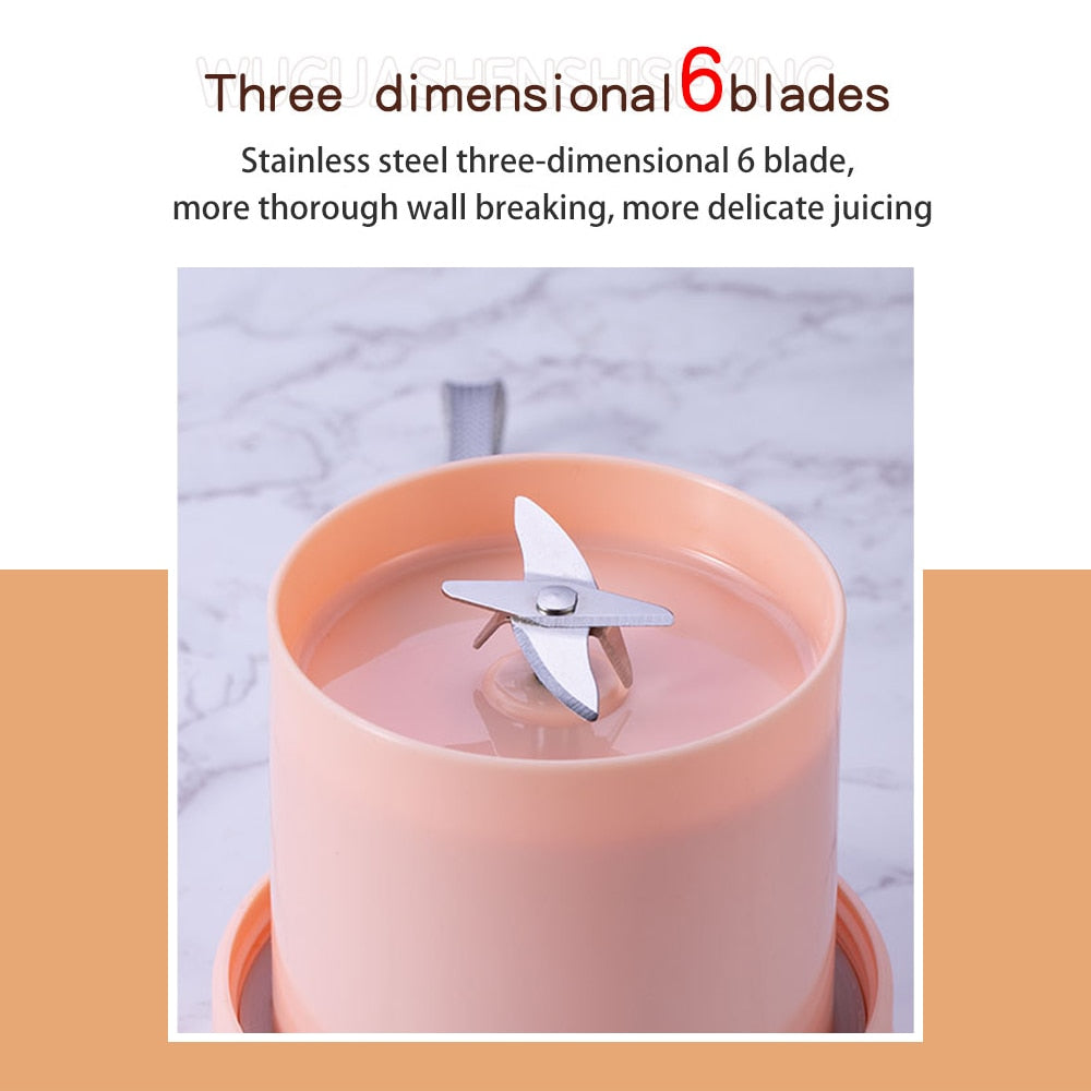 Portable Juicer Cup in green and pink colors with USB charging cable, showcasing its compact design and 6-leaf blade.