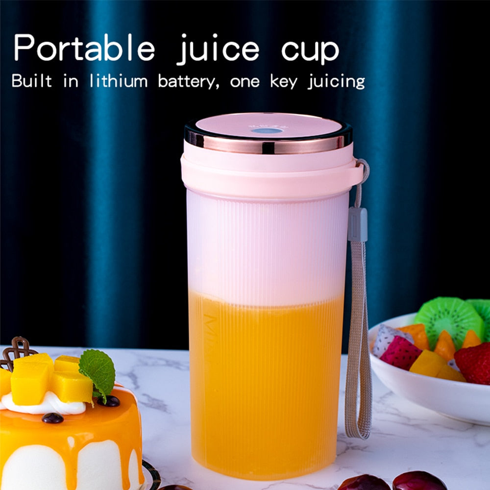 Portable Juicer Cup in green and pink colors with USB charging cable, showcasing its compact design and 6-leaf blade.