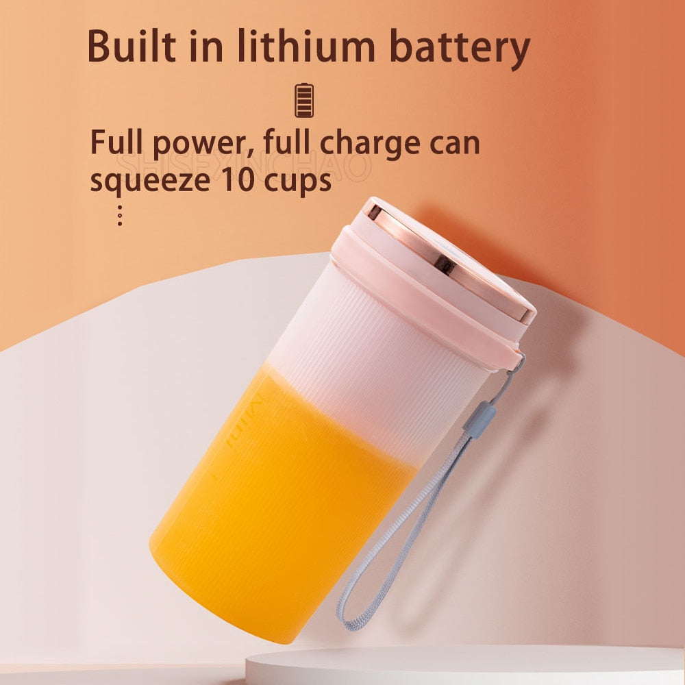 Portable Juicer Cup in green and pink colors with USB charging cable, showcasing its compact design and 6-leaf blade.