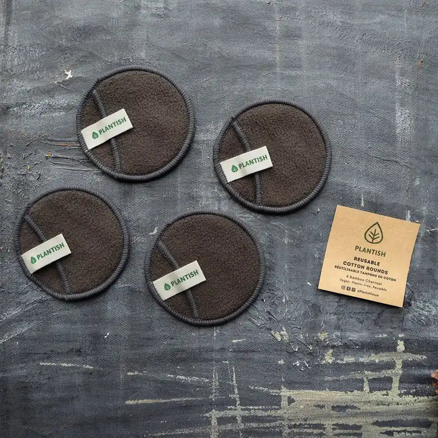 Reusable cotton rounds made from bamboo charcoal, displayed in an organic mesh bag, showcasing their eco-friendly design.