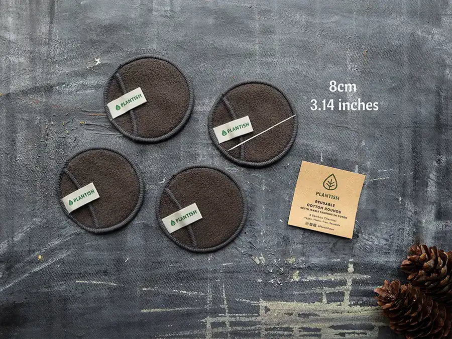 Reusable cotton rounds made from bamboo charcoal, displayed in an organic mesh bag, showcasing their eco-friendly design.