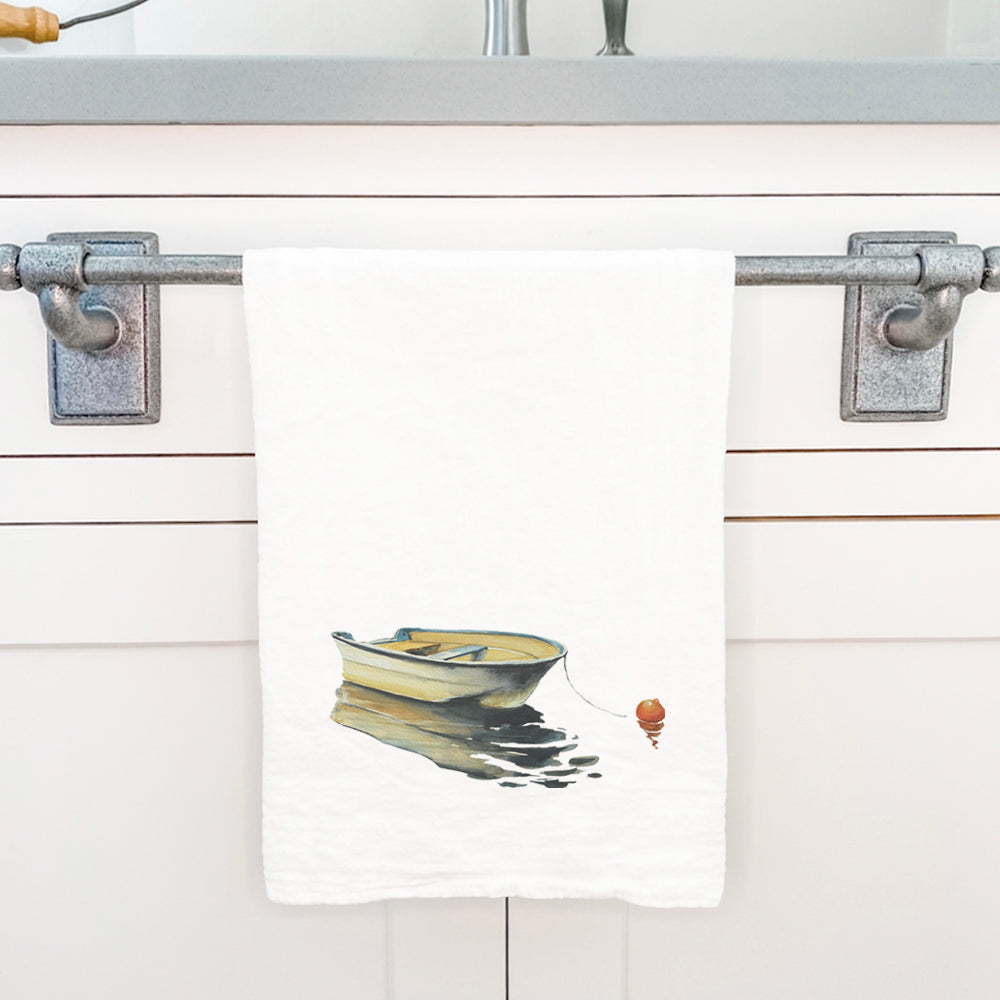 Cotton tea towel featuring a serene rowboat design on still water, showcasing vibrant colors and hemmed edges.