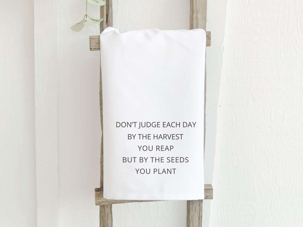 Seeds Quote Cotton Tea Towel featuring vibrant design and hemmed edges, perfect for kitchen use.