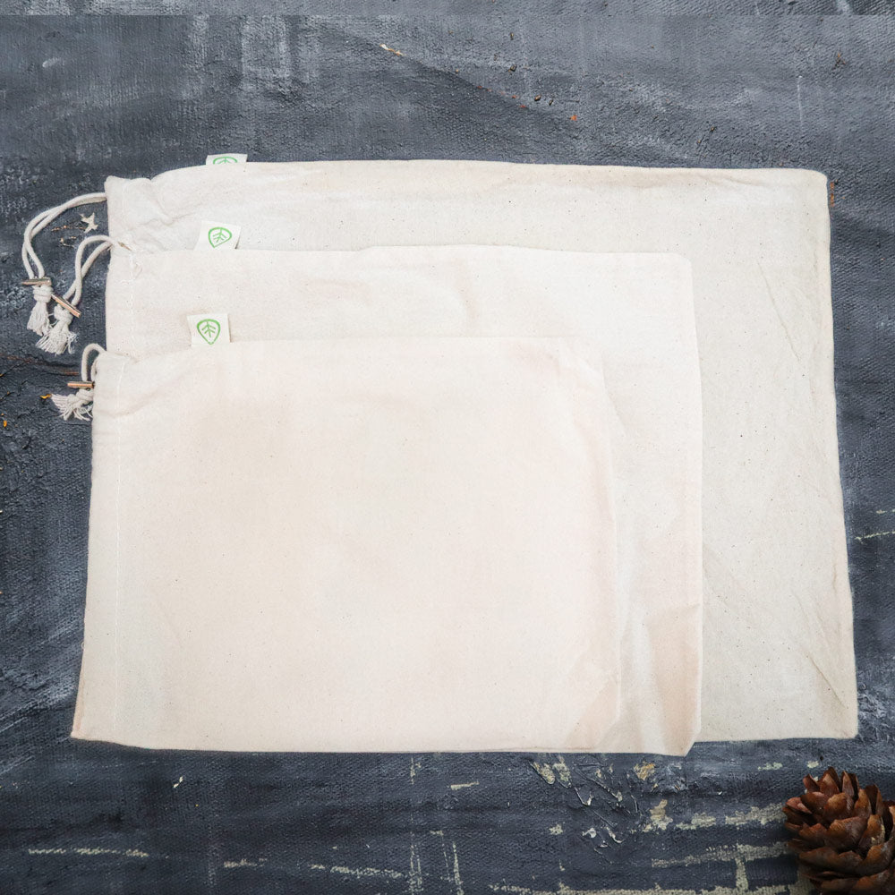 Set of 4 Organic Cotton Muslin Produce Bags in various sizes, ideal for eco-friendly storage and shopping.
