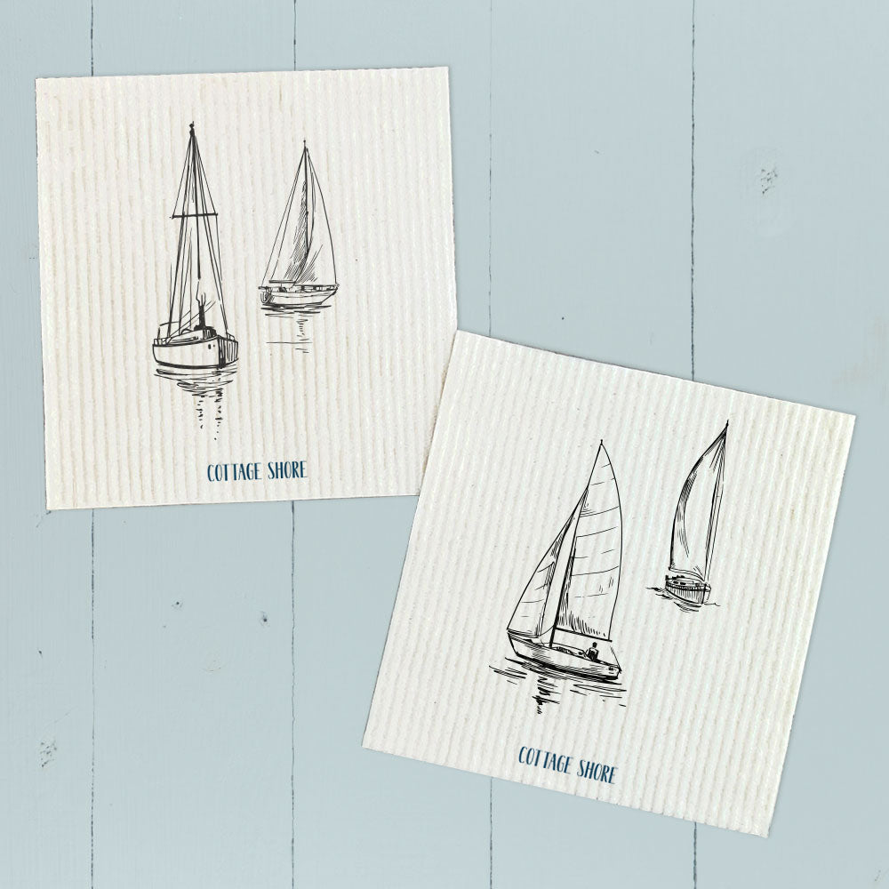 Two eco-friendly Swedish dish cloths featuring sketched sailboat designs, made from plant-based fibers.