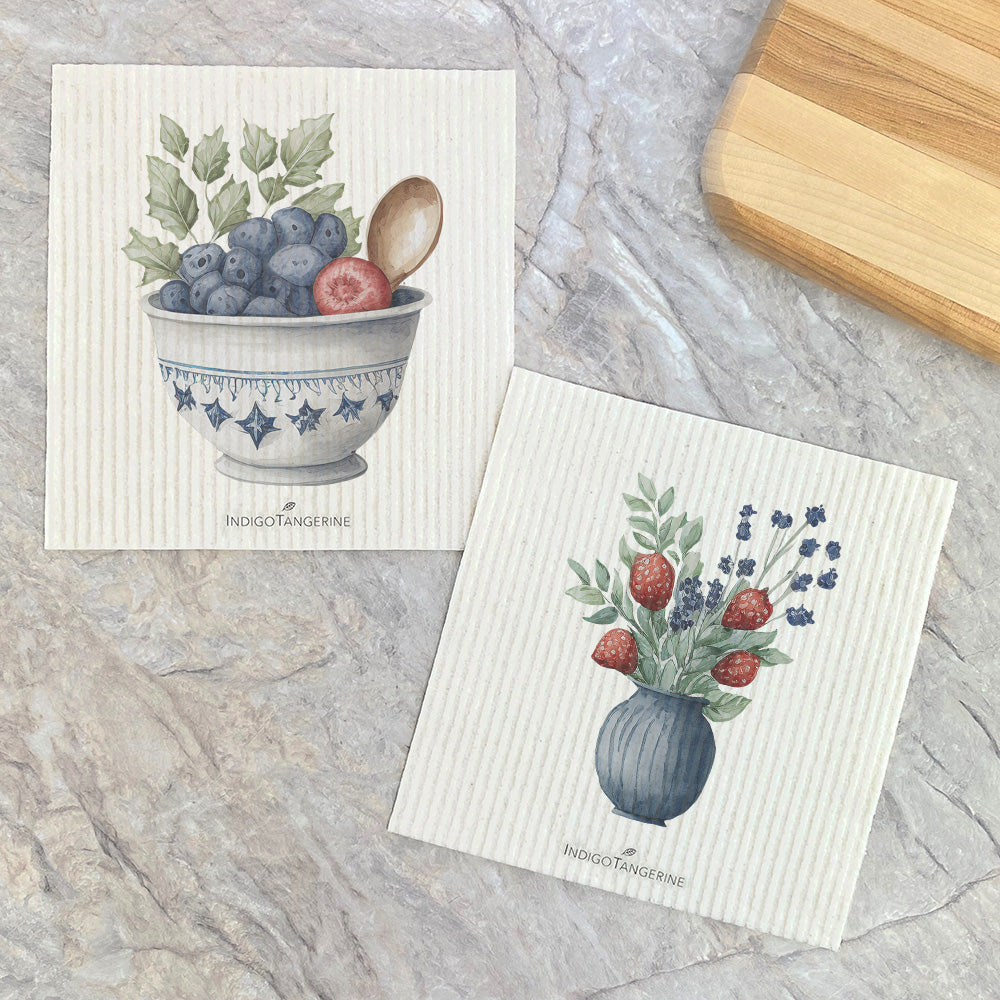 A pack of two eco-friendly Swedish dishcloths featuring a vibrant strawberry bouquet design, made from plant-based fibers.