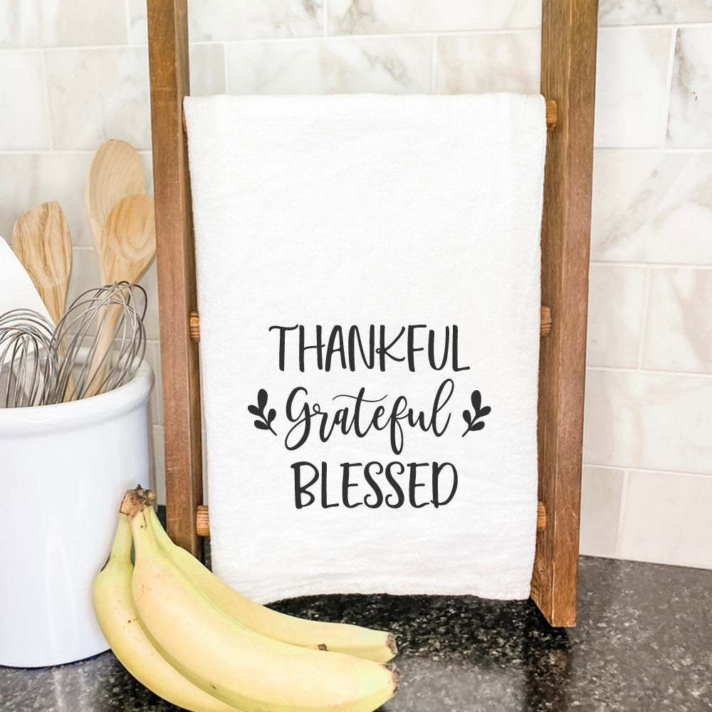 Thankful Grateful Blessed cotton tea towel featuring a vibrant design, perfect for kitchen use.