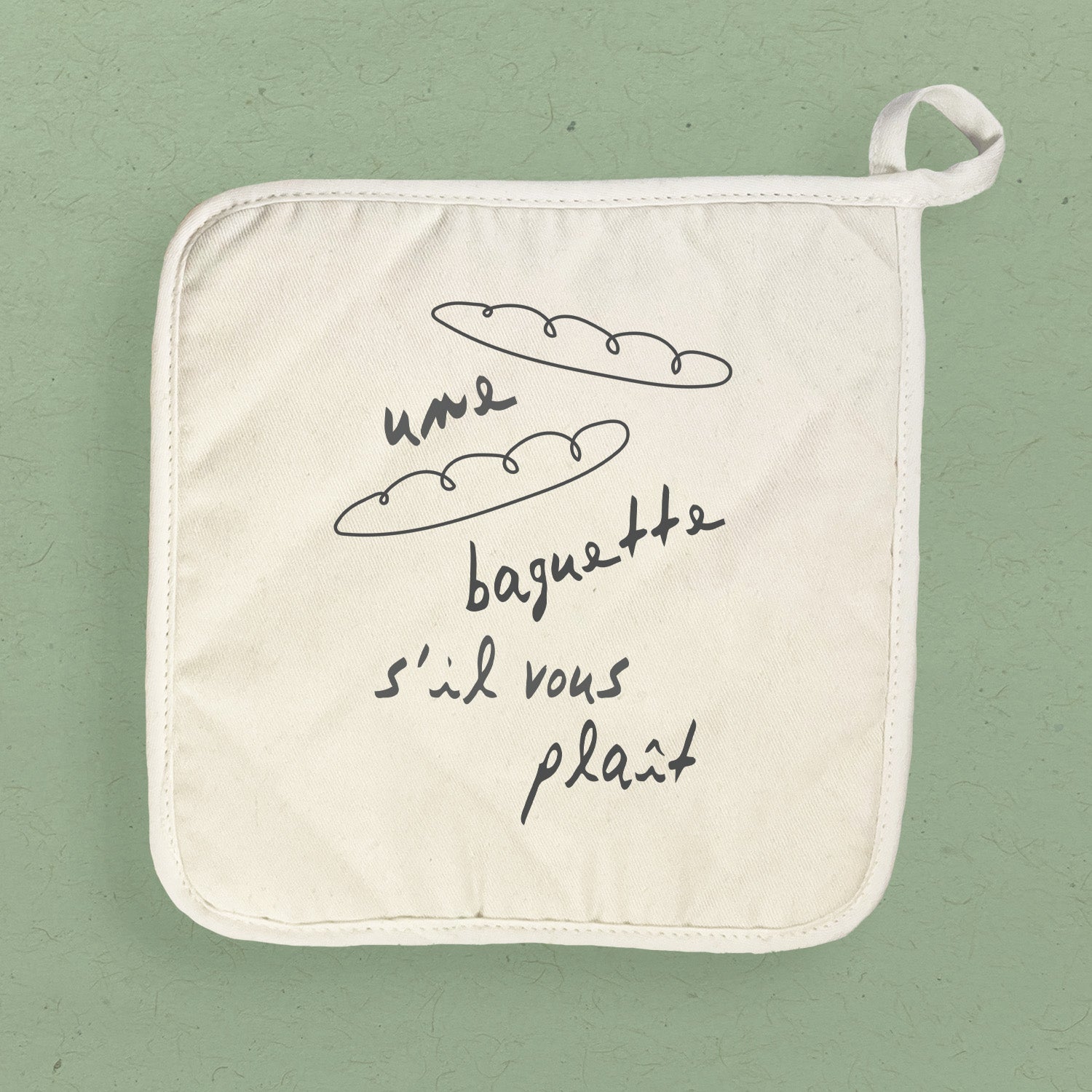 A stylish Une Baguette Cotton Pot Holder featuring vibrant designs, made from durable cotton and terry cloth, perfect for protecting surfaces.