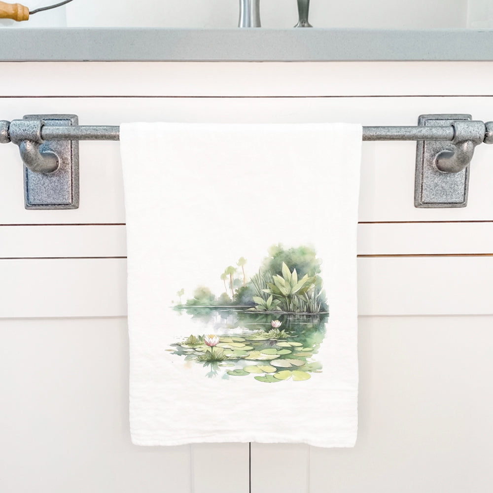 A vibrant cotton tea towel featuring a beautiful water lily design, perfect for kitchen use.