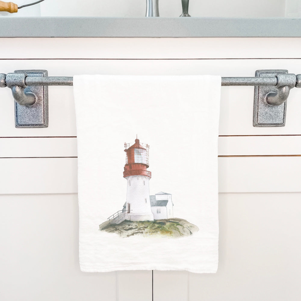 A vibrant cotton tea towel featuring a watercolor lighthouse design, perfect for kitchen use.