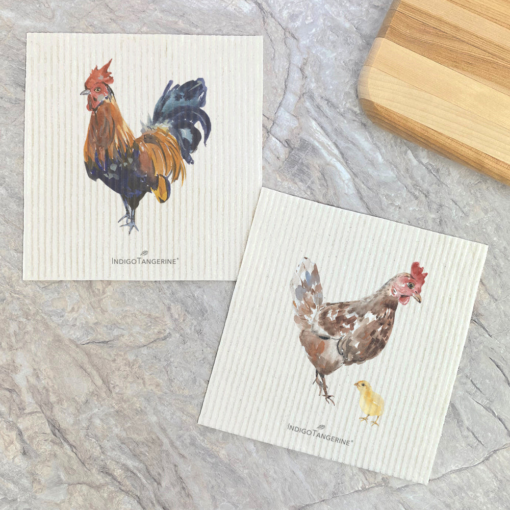 Two Swedish dishcloths featuring watercolor designs of a rooster, hen, and chick, showcasing eco-friendly materials.