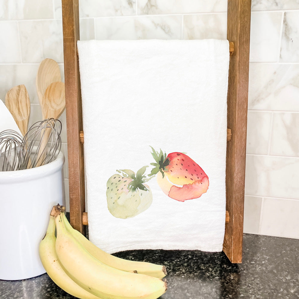 A vibrant cotton tea towel featuring a watercolor strawberry design, perfect for kitchen use.