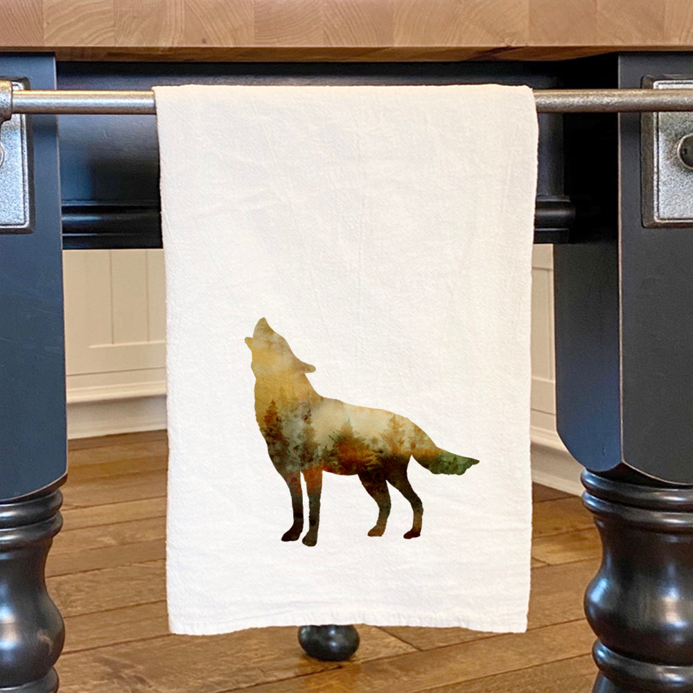 A vibrant watercolor wolf design on a cotton tea towel, showcasing its absorbent texture and hemmed edges.