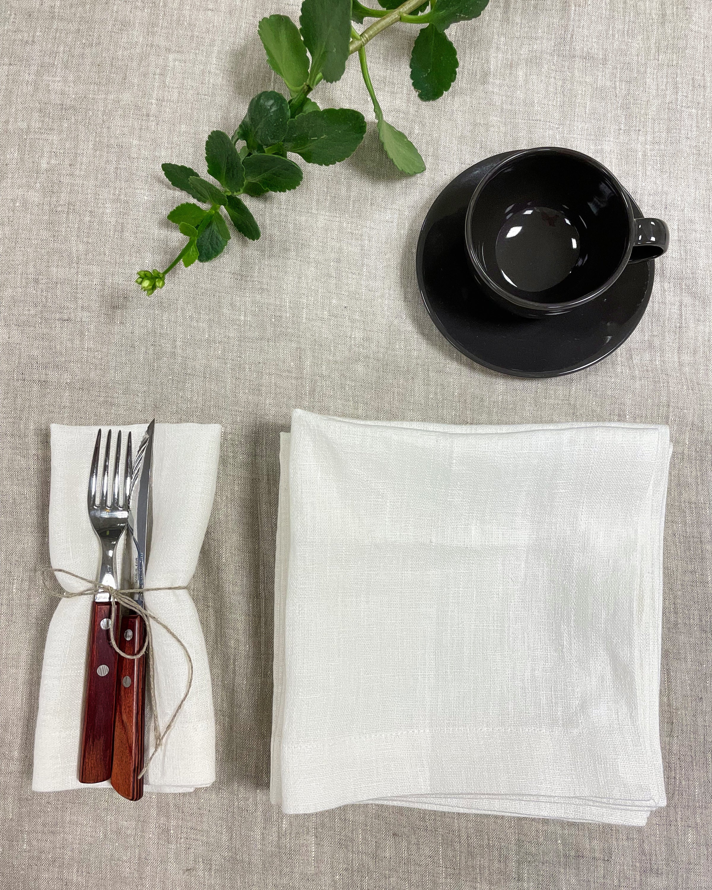 Set of two white linen napkins made from 100% stonewashed linen, featuring a decorative hem and soft texture, perfect for elegant dining.