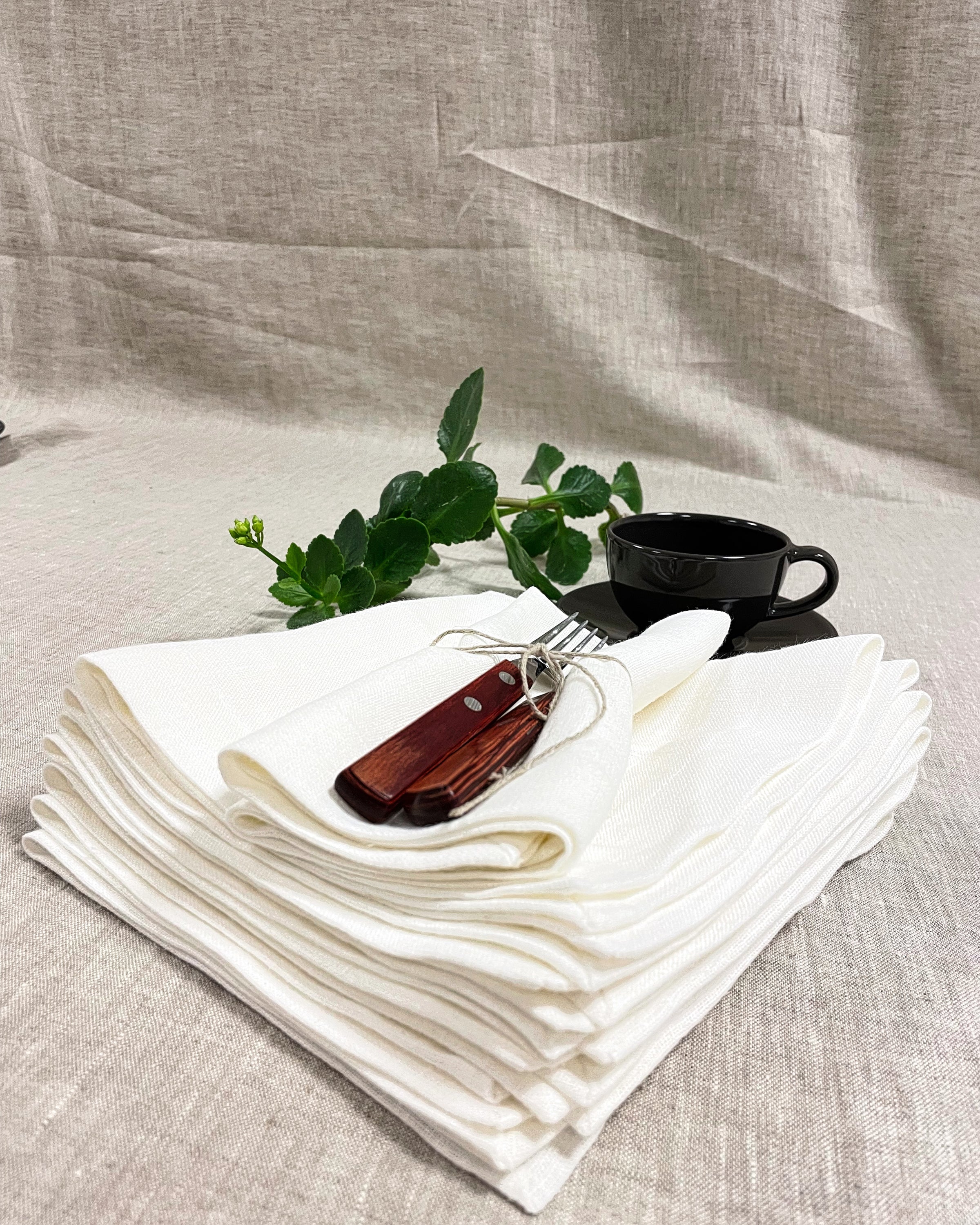 Set of two white linen napkins made from 100% stonewashed linen, featuring a decorative hem and soft texture, perfect for elegant dining.