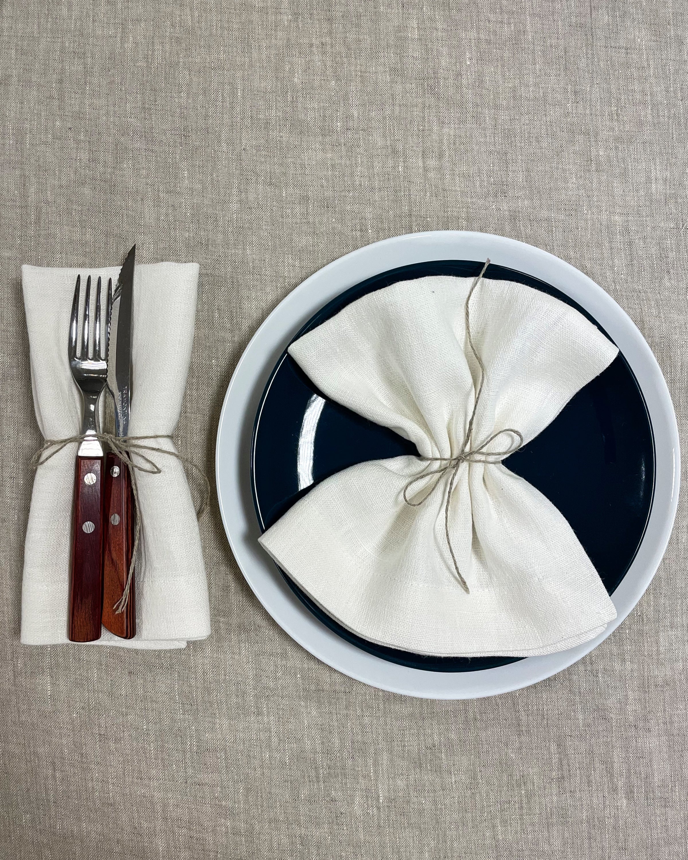 Set of two white linen napkins made from 100% stonewashed linen, featuring a decorative hem and soft texture, perfect for elegant dining.