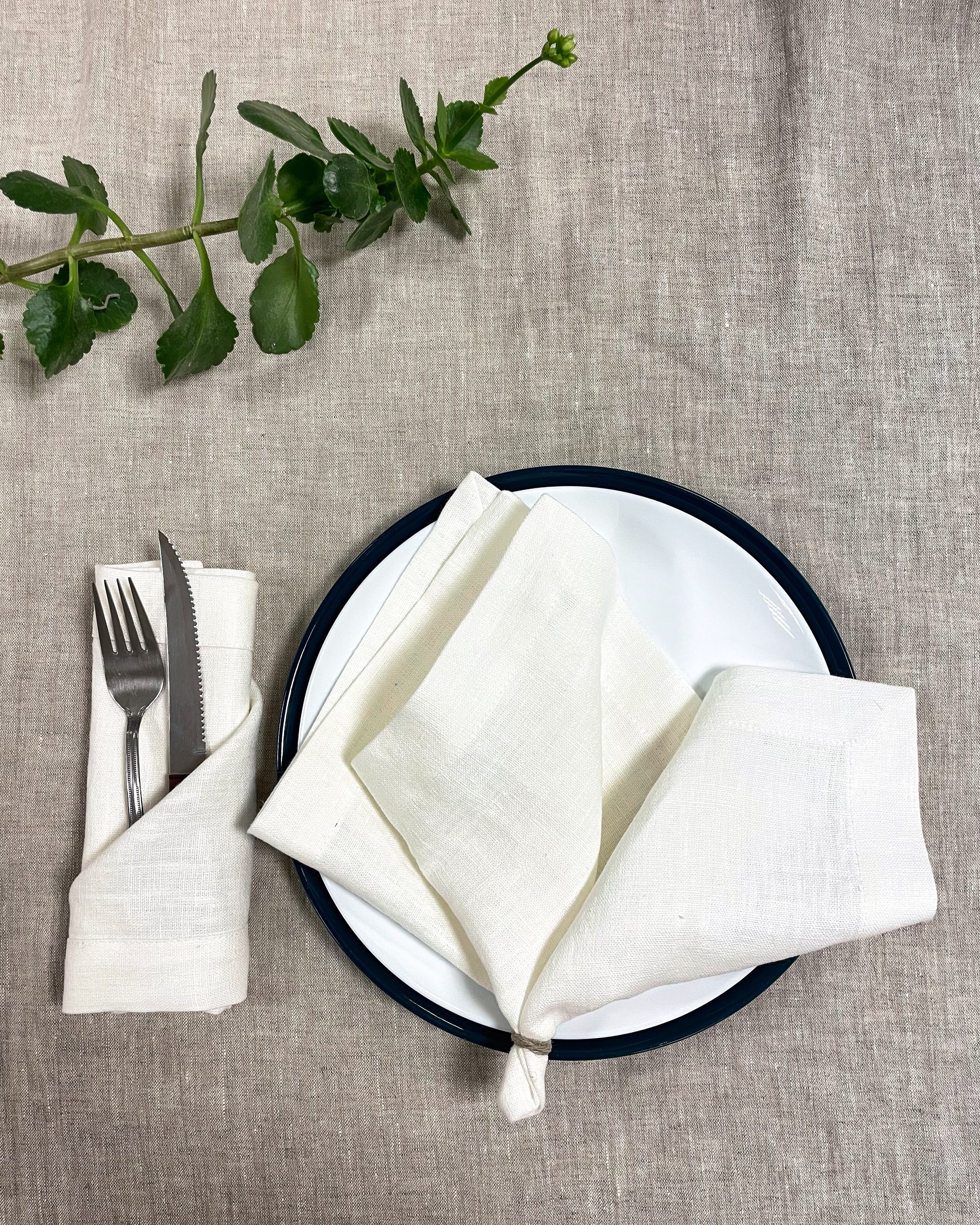 Set of two white linen napkins made from 100% stonewashed linen, featuring a decorative hem and soft texture, perfect for elegant dining.