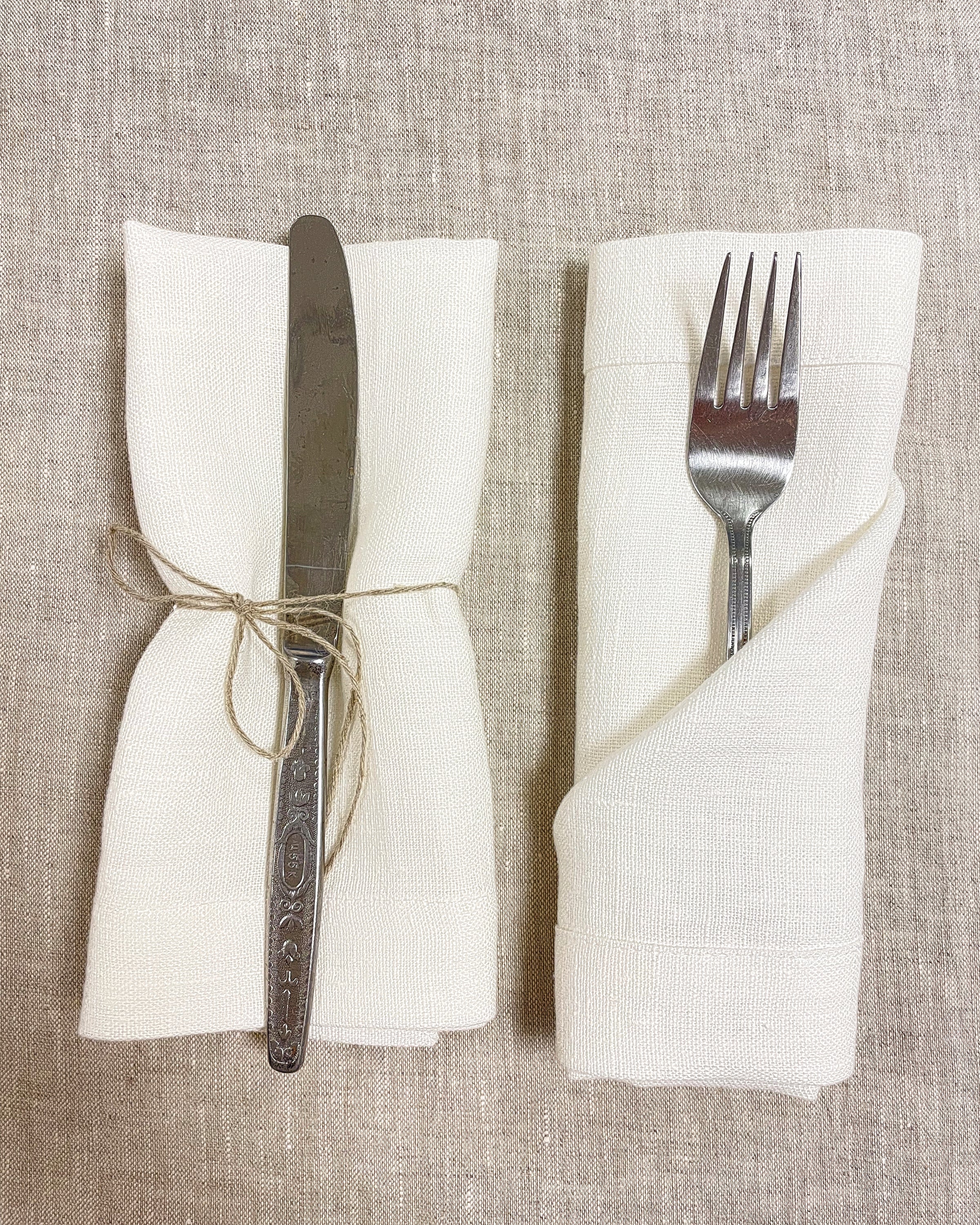 Set of two white linen napkins made from 100% stonewashed linen, featuring a decorative hem and soft texture, perfect for elegant dining.
