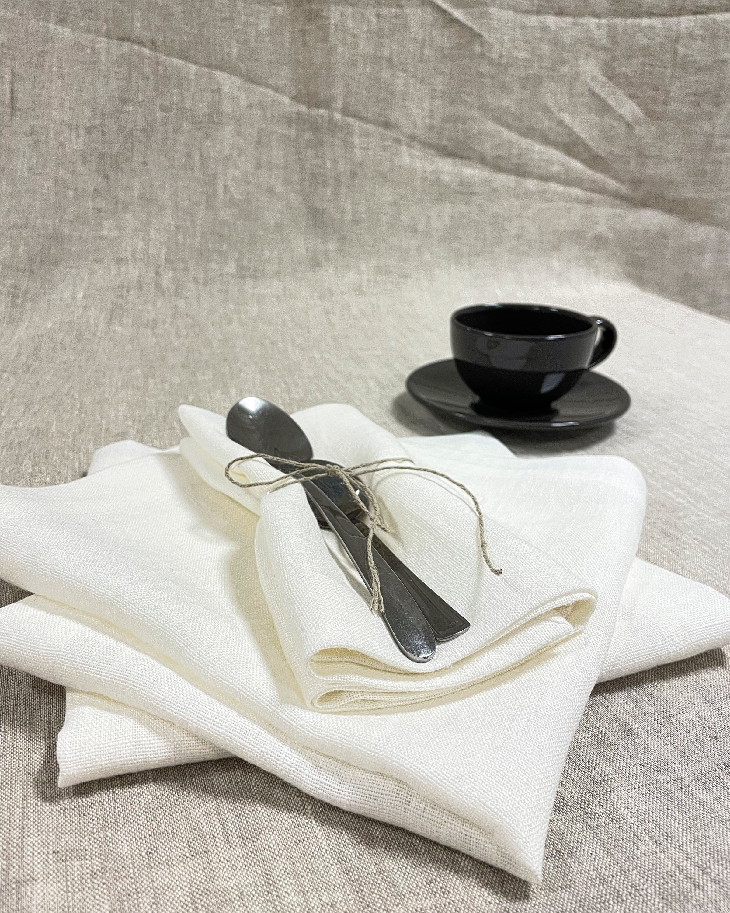 Set of two white linen napkins made from 100% stonewashed linen, featuring a decorative hem and soft texture, perfect for elegant dining.