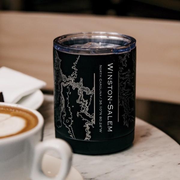 Matte black insulated cup featuring a custom engraved map of Winston-Salem, North Carolina with coordinates.