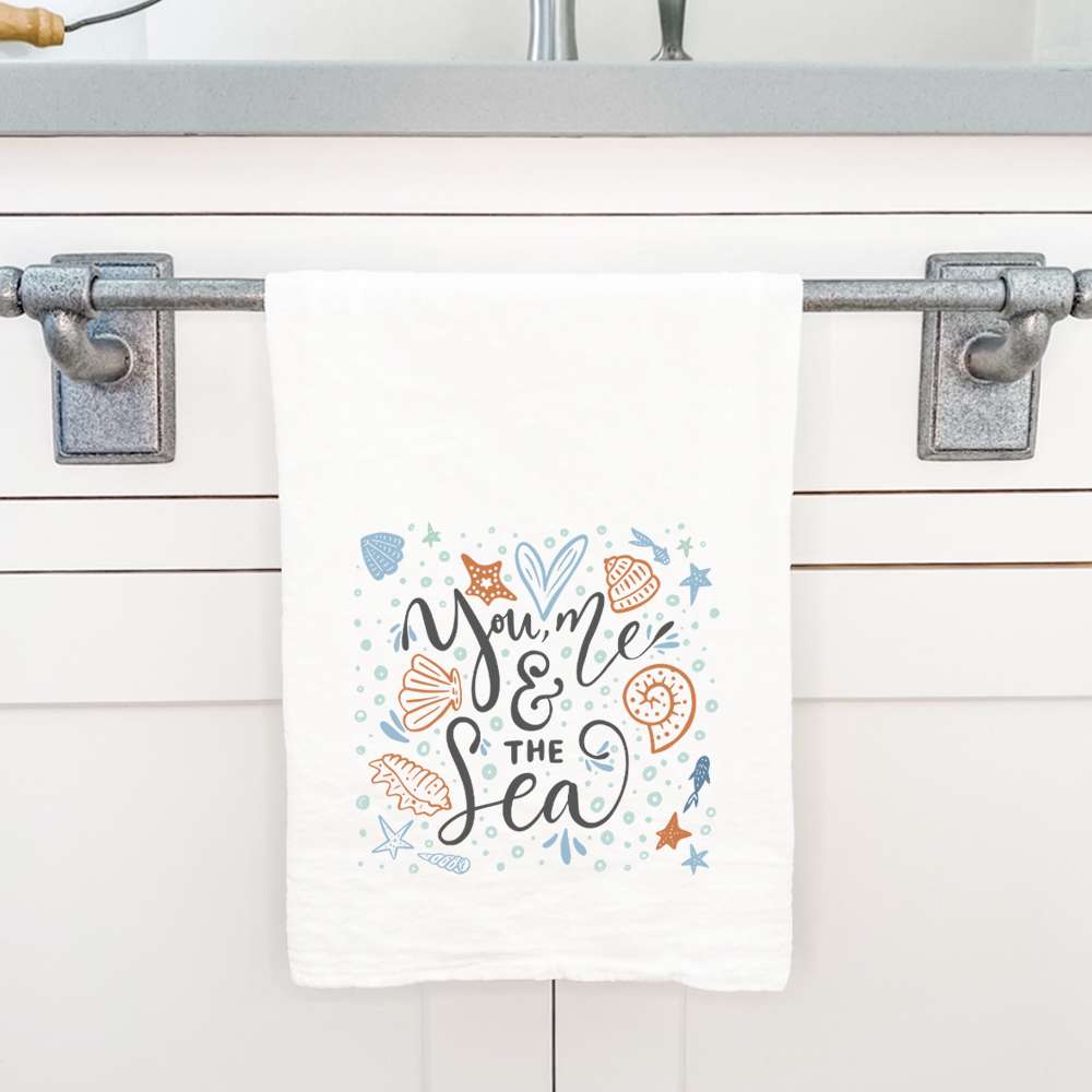 You Me and the Sea Cotton Tea Towel featuring vibrant water-based ink designs on absorbent 100% cotton fabric, measuring 27 inches square.