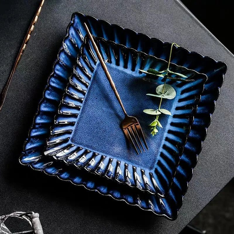 Zurbaa Square Plate featuring deep blue color and ruffled edges, ideal for serving sushi and sashimi.