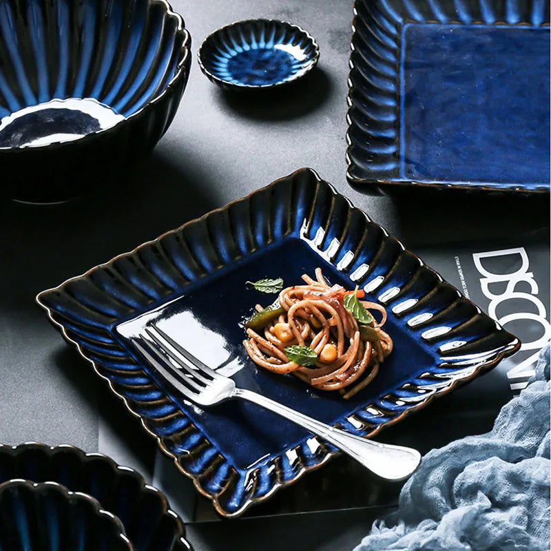 Zurbaa Square Plate featuring deep blue color and ruffled edges, ideal for serving sushi and sashimi.