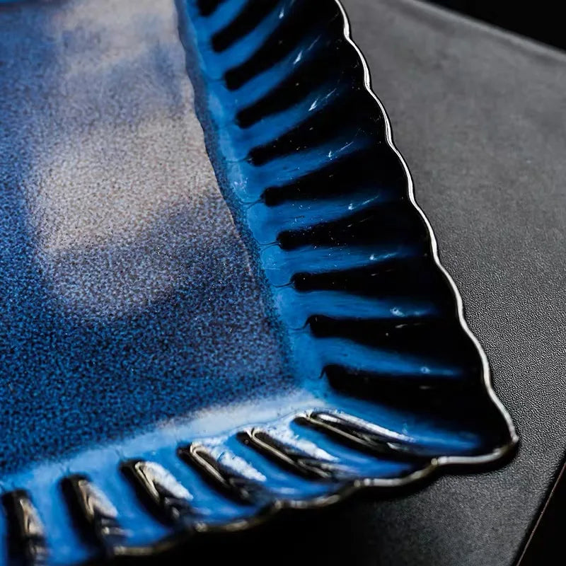 Zurbaa Square Plate featuring deep blue color and ruffled edges, ideal for serving sushi and sashimi.