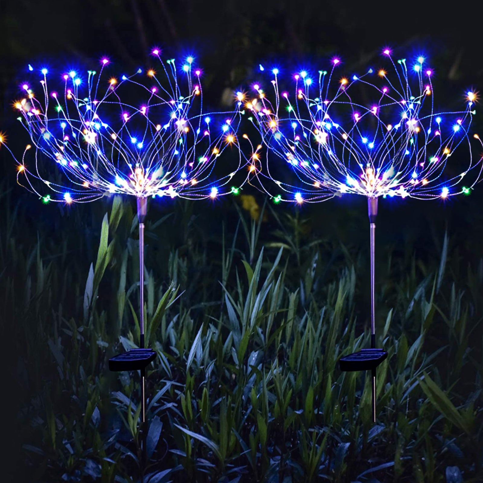 Two 180 LED Solar Firework Lights in a garden setting, showcasing vibrant colors and customizable shapes.