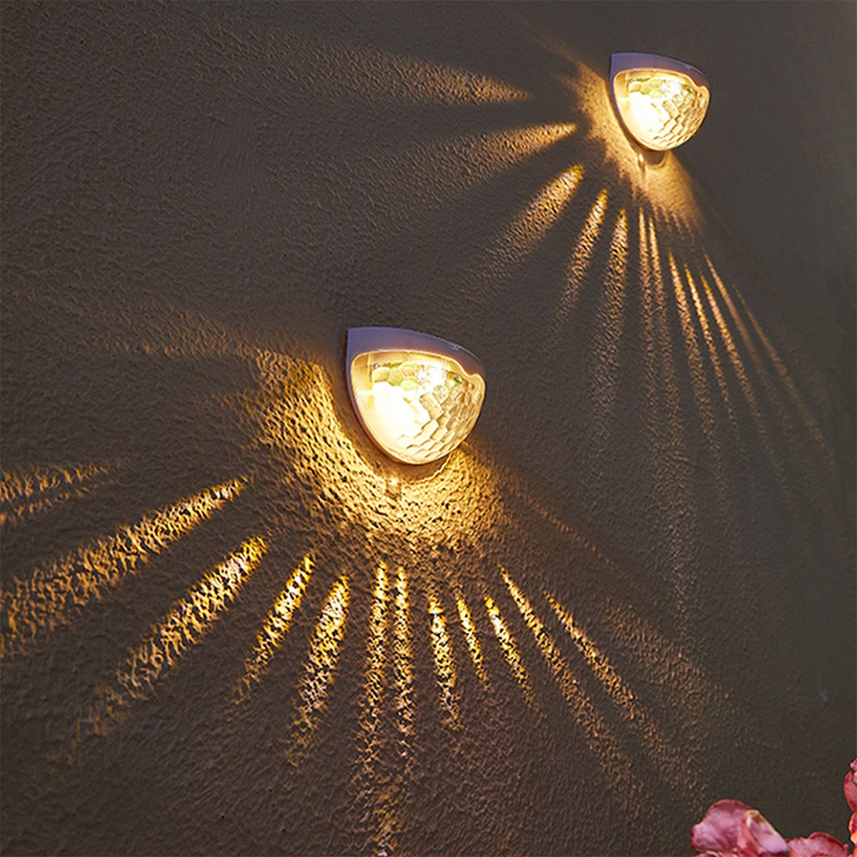 Two solar semicircle wall lights with fish scale design, waterproof and suitable for outdoor use, illuminating a garden area.