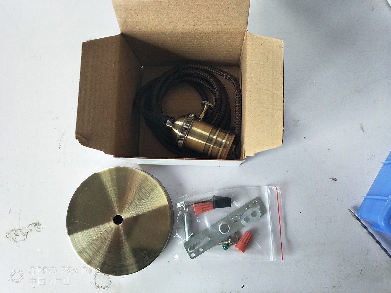 A stylish 2-inch antique brass bare bulb LED pendant light with a retro switch, featuring a woven cord and a vintage dimmable LED bulb.