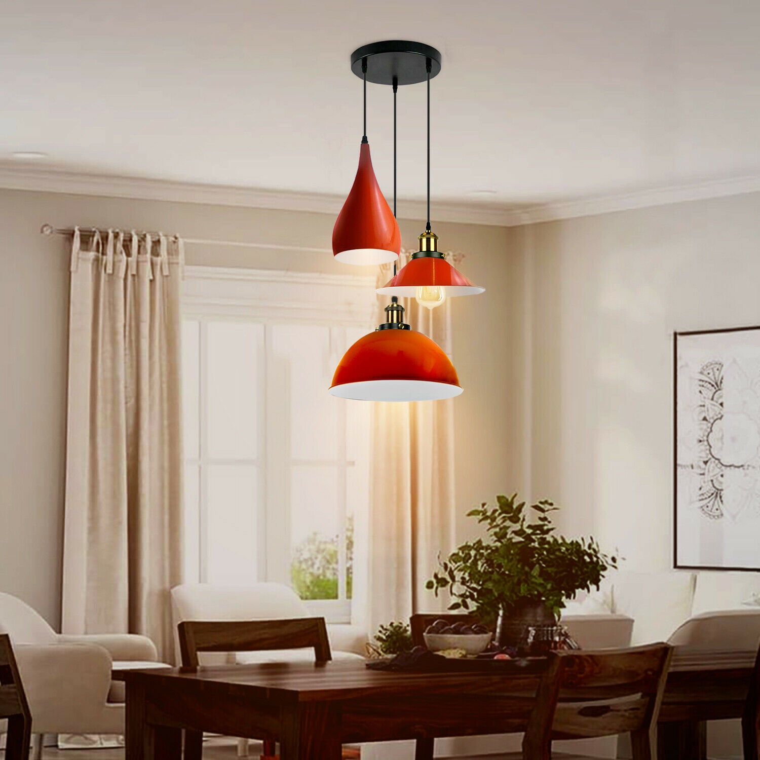 Three head pendant light fixture in orange metal, showcasing a modern design with three light holders and a round ceiling plate.
