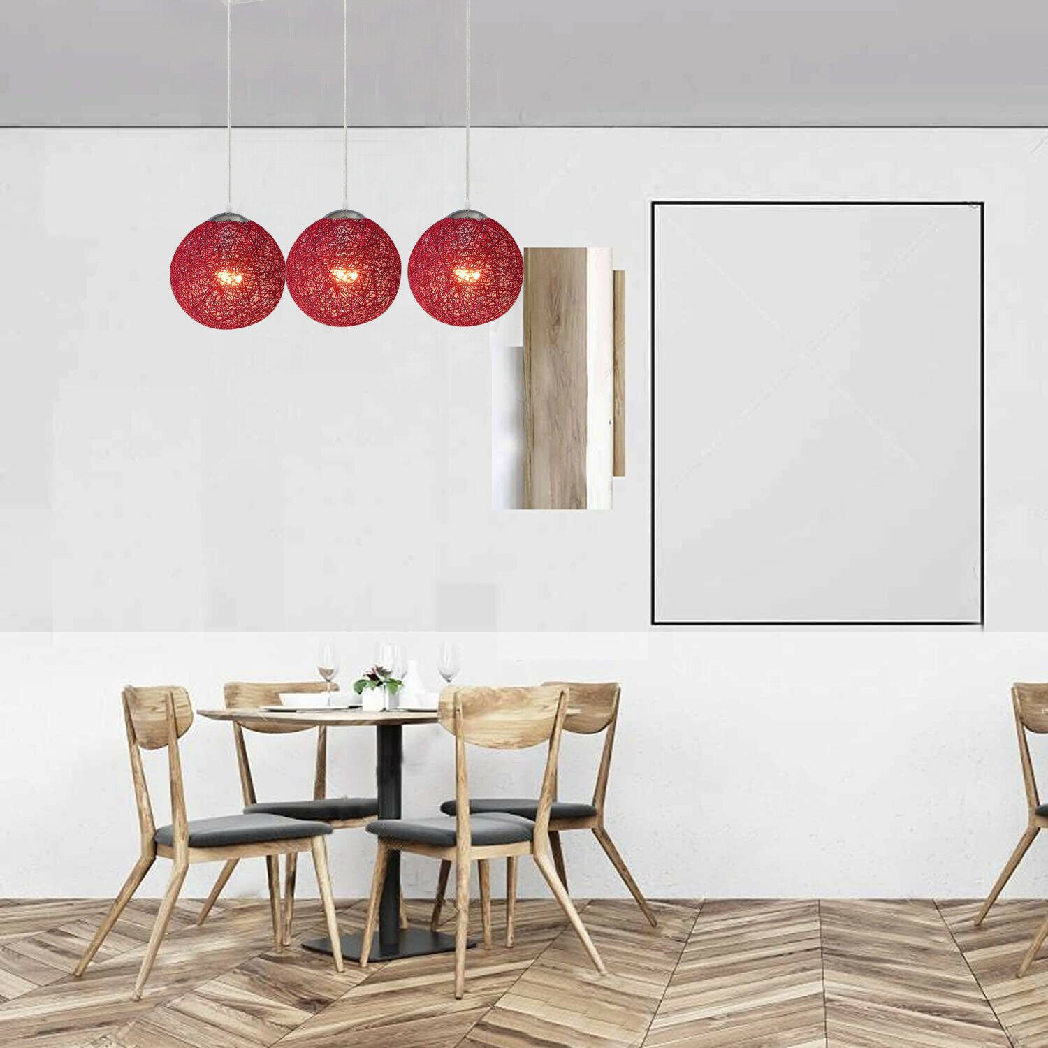 Three red rattan pendant lights hanging elegantly, showcasing intricate wicker design and warm illumination.