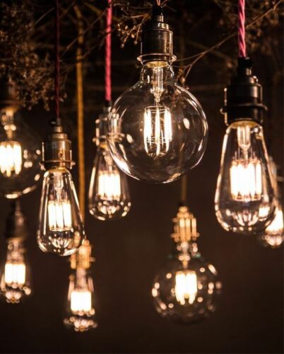 Three vintage-style G95 E27 8W LED globe light bulbs with a warm white glow, showcasing their retro design and glass material.