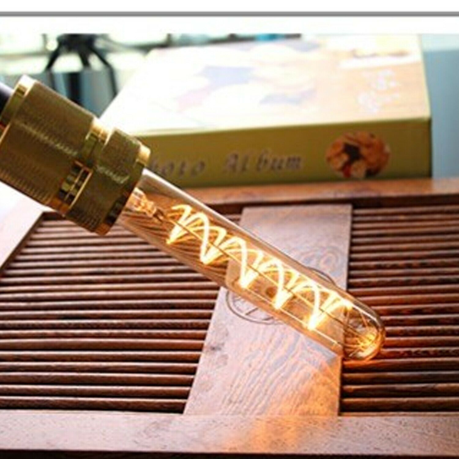 Three LED E27 T185 4W Filament Glass Retro Warm White bulbs showcasing their elegant design and warm glow.