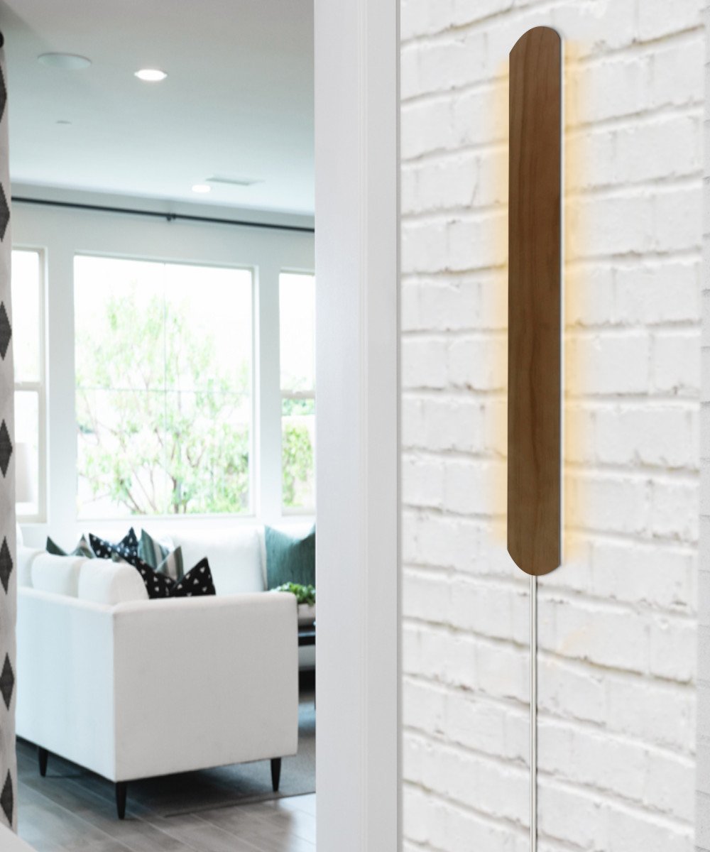 3-inch wide solid wood Hover Plank accent light, 24 inches tall, featuring a medium oak finish, designed for corner or wall installation with a dimmable LED.