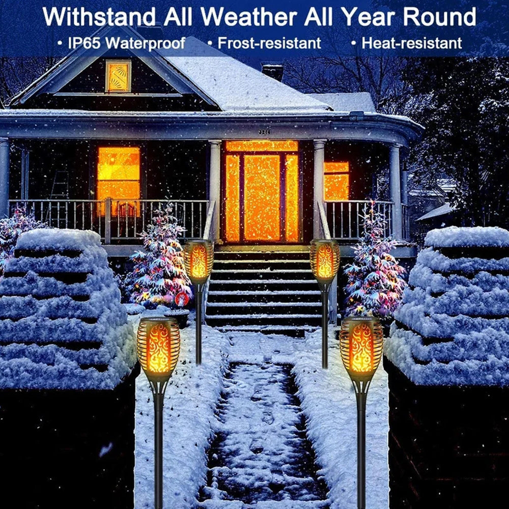 Four solar lights with flickering flame effect, designed for outdoor use, showcasing a romantic ambiance in a garden setting.