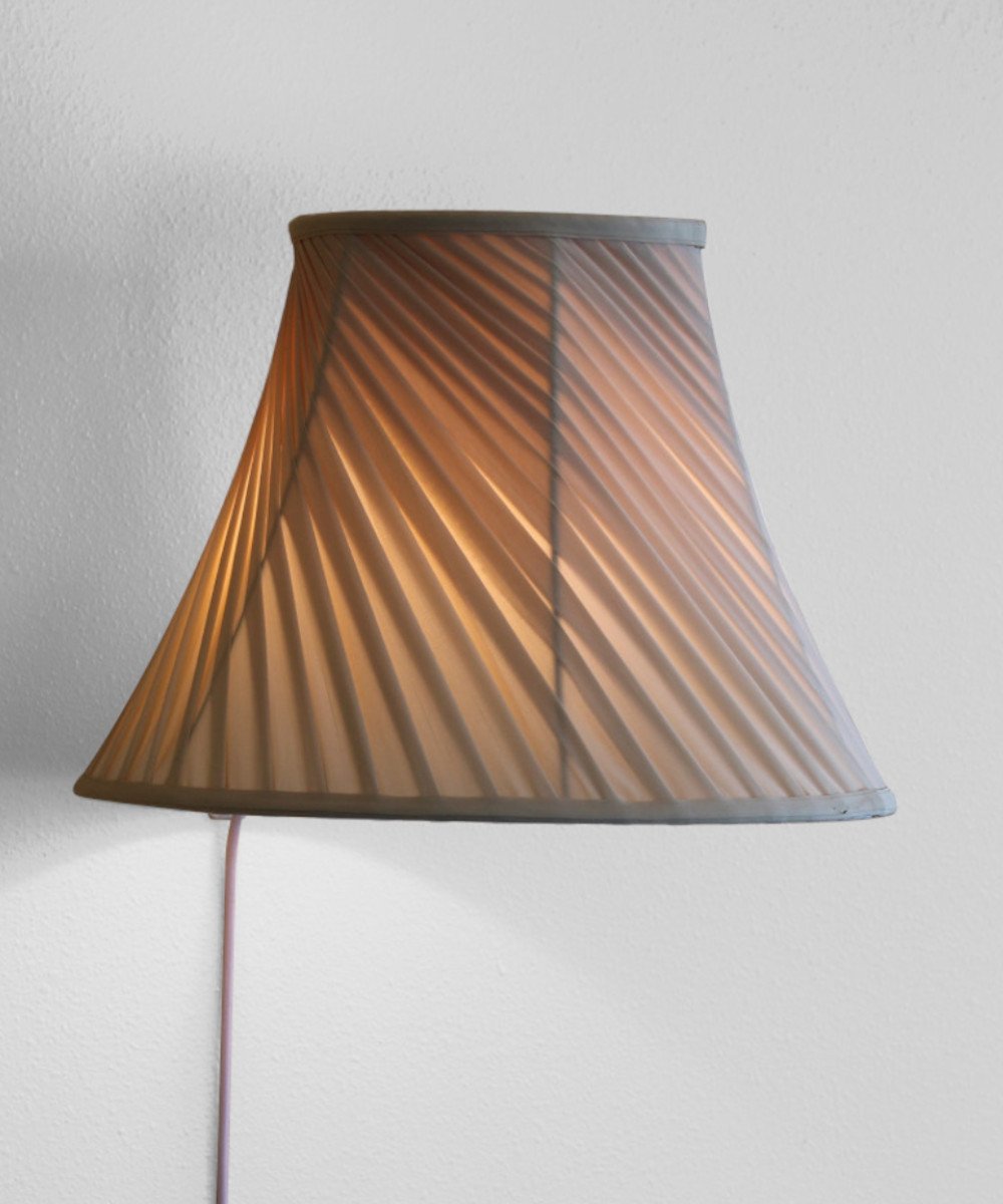 8-inch floating shade plug-in wall light with eggshell silk fabric, minimalist design, and rotary dimmer switch.