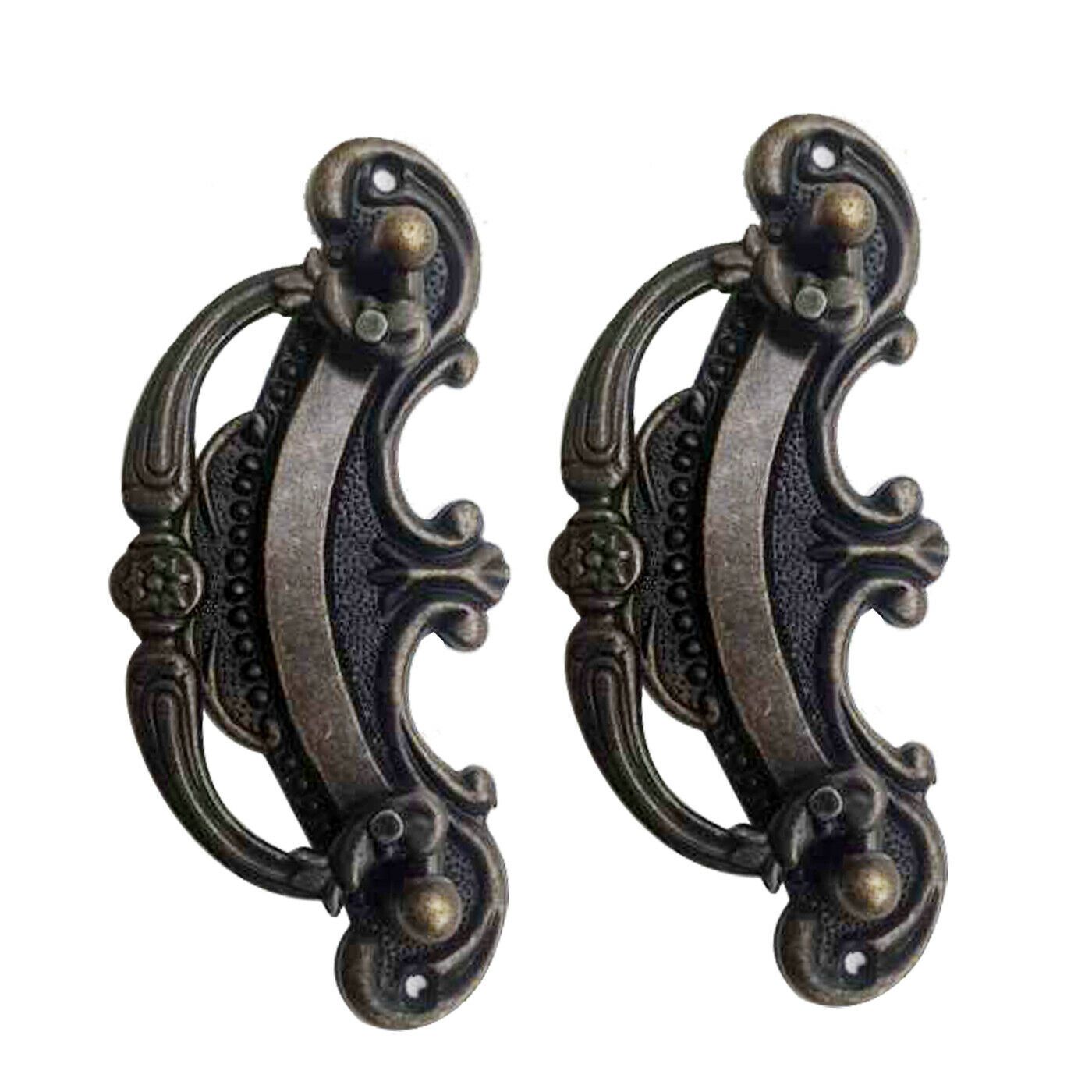 Antique style metal door and cupboard handles in a vintage design, made of durable zinc alloy, displayed on a wooden surface.