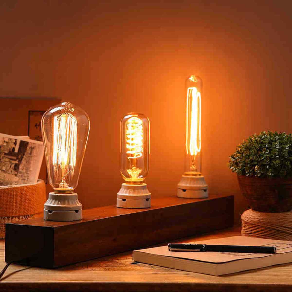 Edison Vintage Light Bulb with B22 bayonet fitting, showcasing a warm yellow glow and classic filament design.