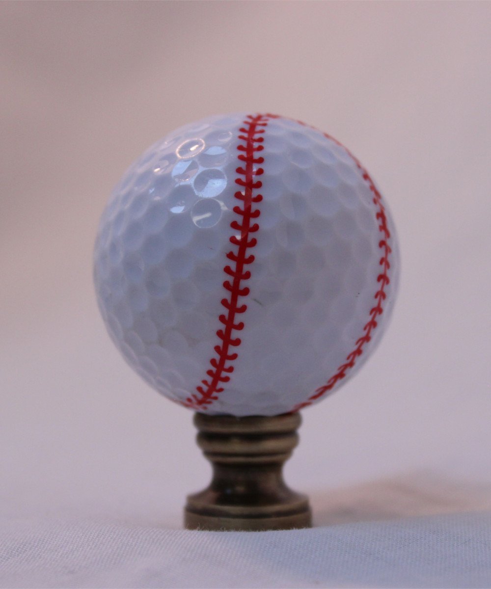 Baseball Lamp Finial featuring a white design with red stitching, crafted in antiqued brass finish, measuring 2.25 inches high.