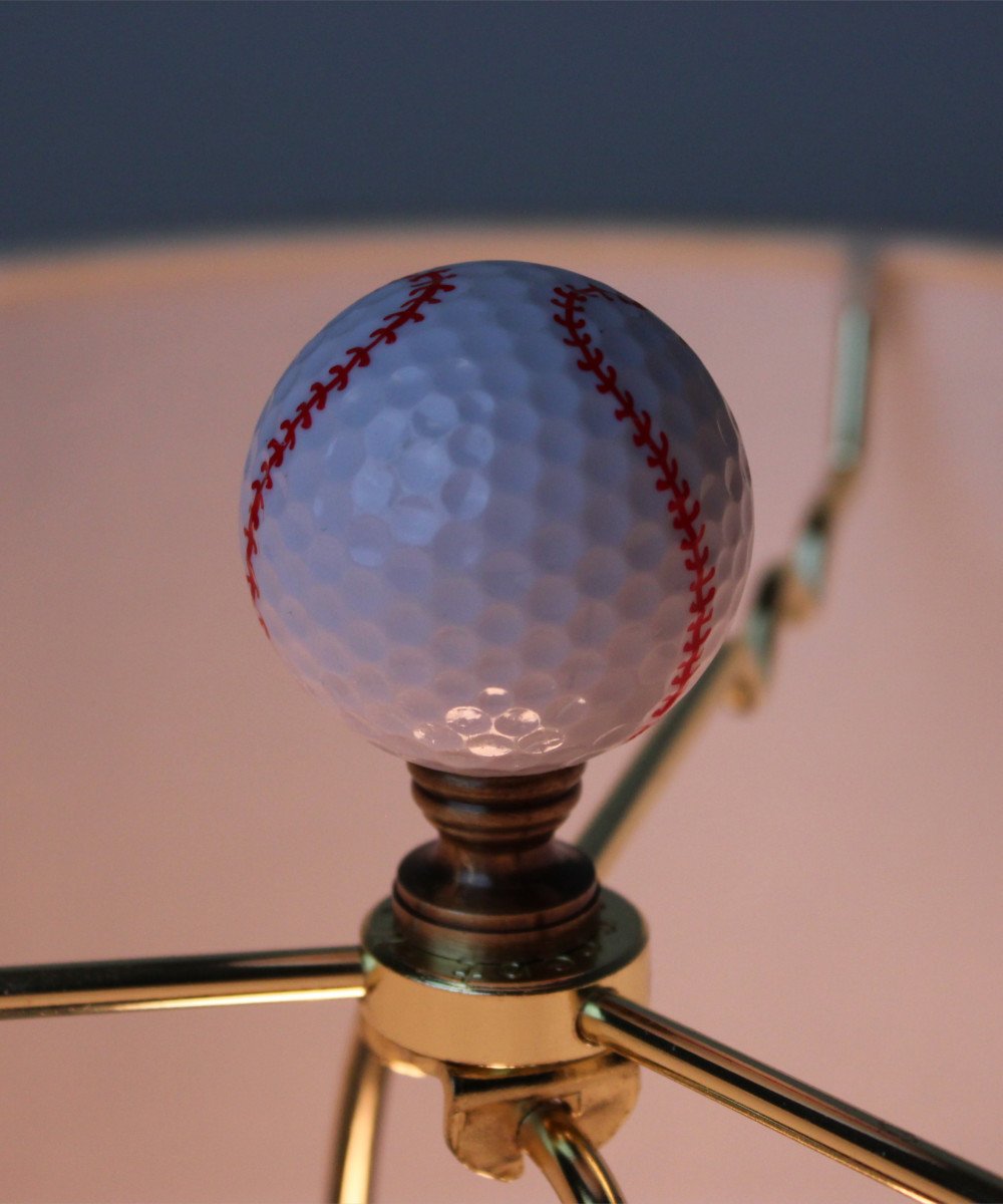 Baseball Lamp Finial featuring a white design with red stitching, crafted in antiqued brass finish, measuring 2.25 inches high.