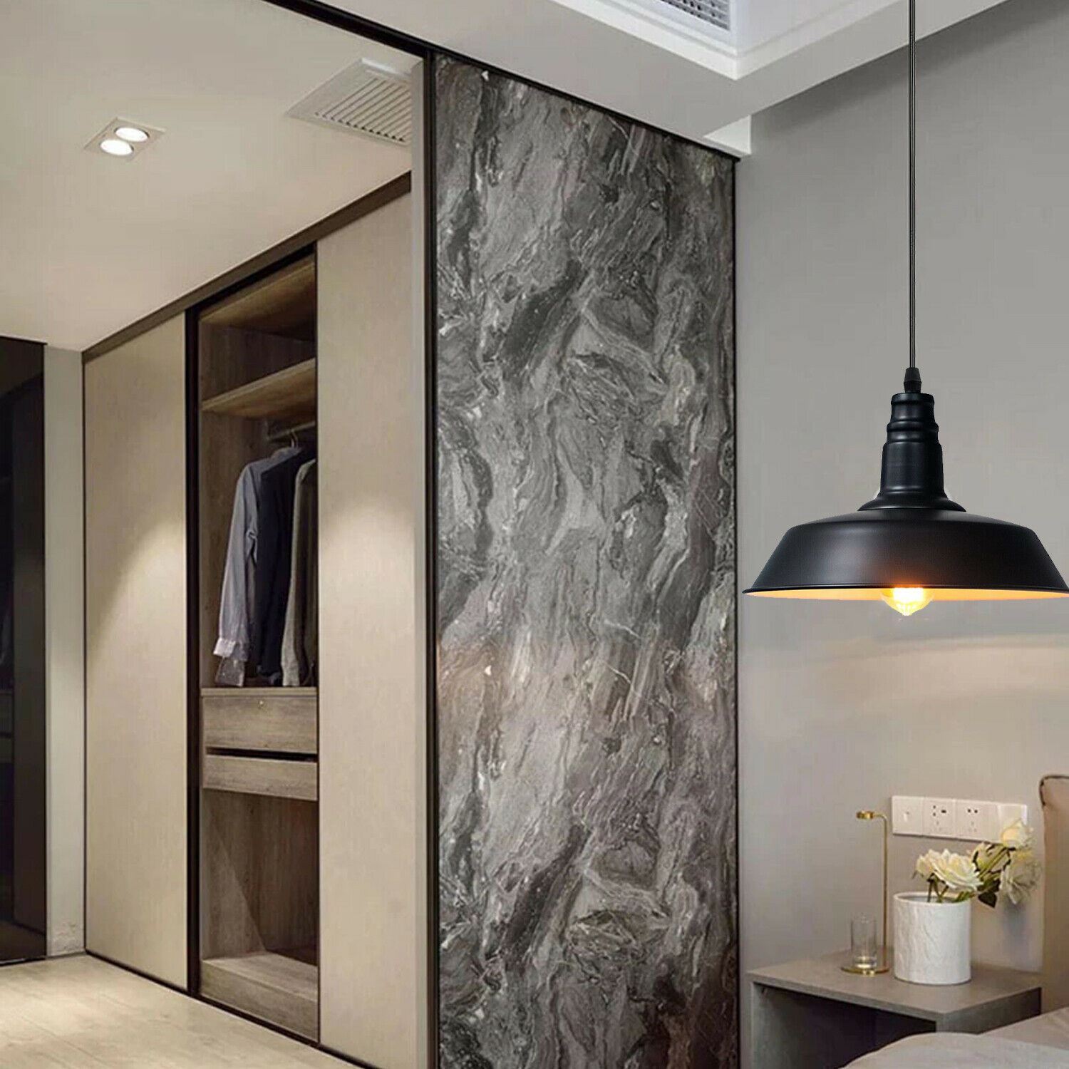 Ceiling pendant light with a sleek metal shade, ideal for indoor decoration, featuring an E27 lamp base and a stylish black finish.