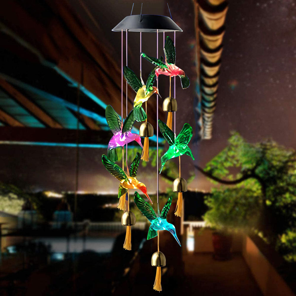 Color Changing Solar Power Wind Chime Crystal Ball hanging in a garden, showcasing vibrant LED colors and a beautiful design.