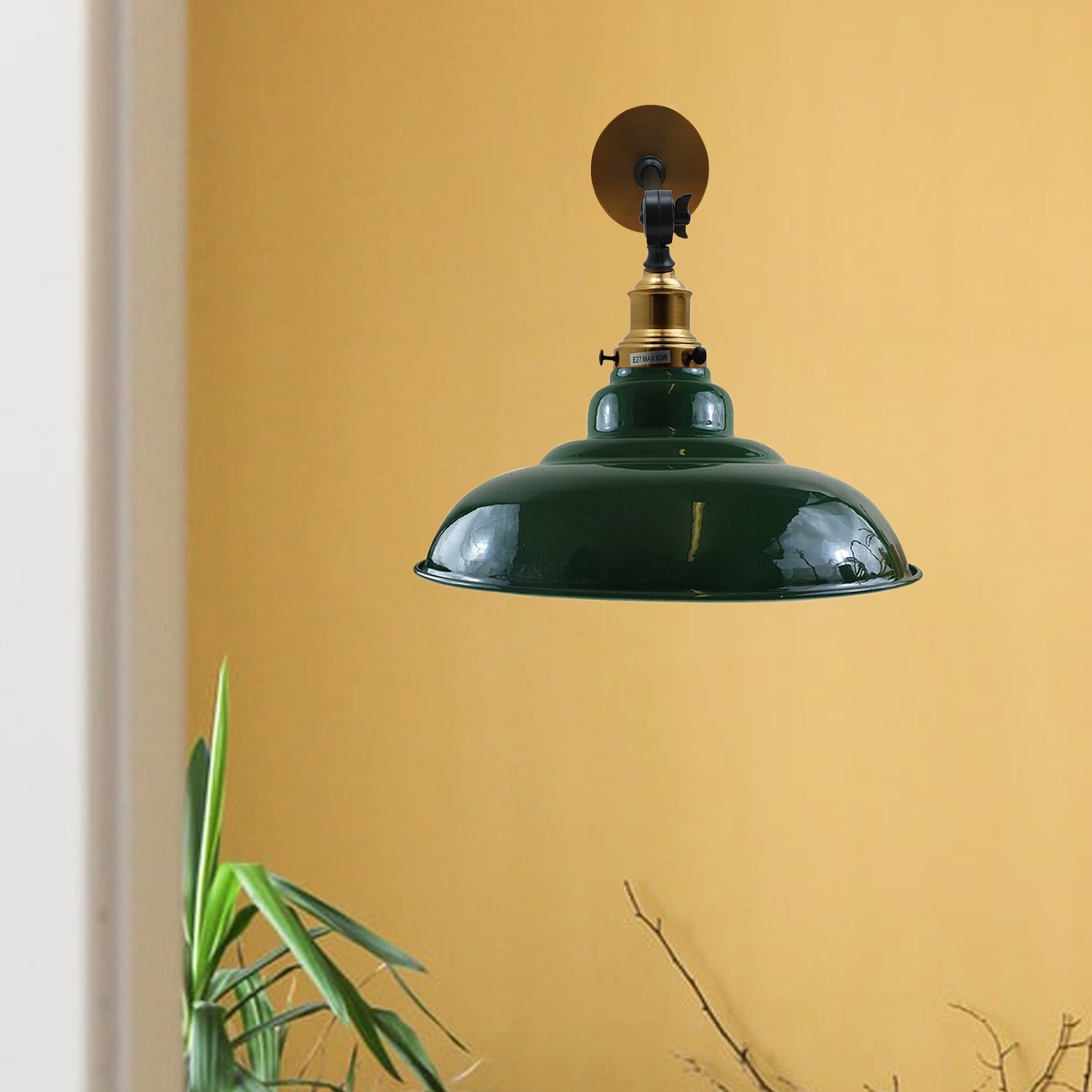 Green adjustable wall light fixture with a curvy swing arm, showcasing a glossy metal shade and vintage design.