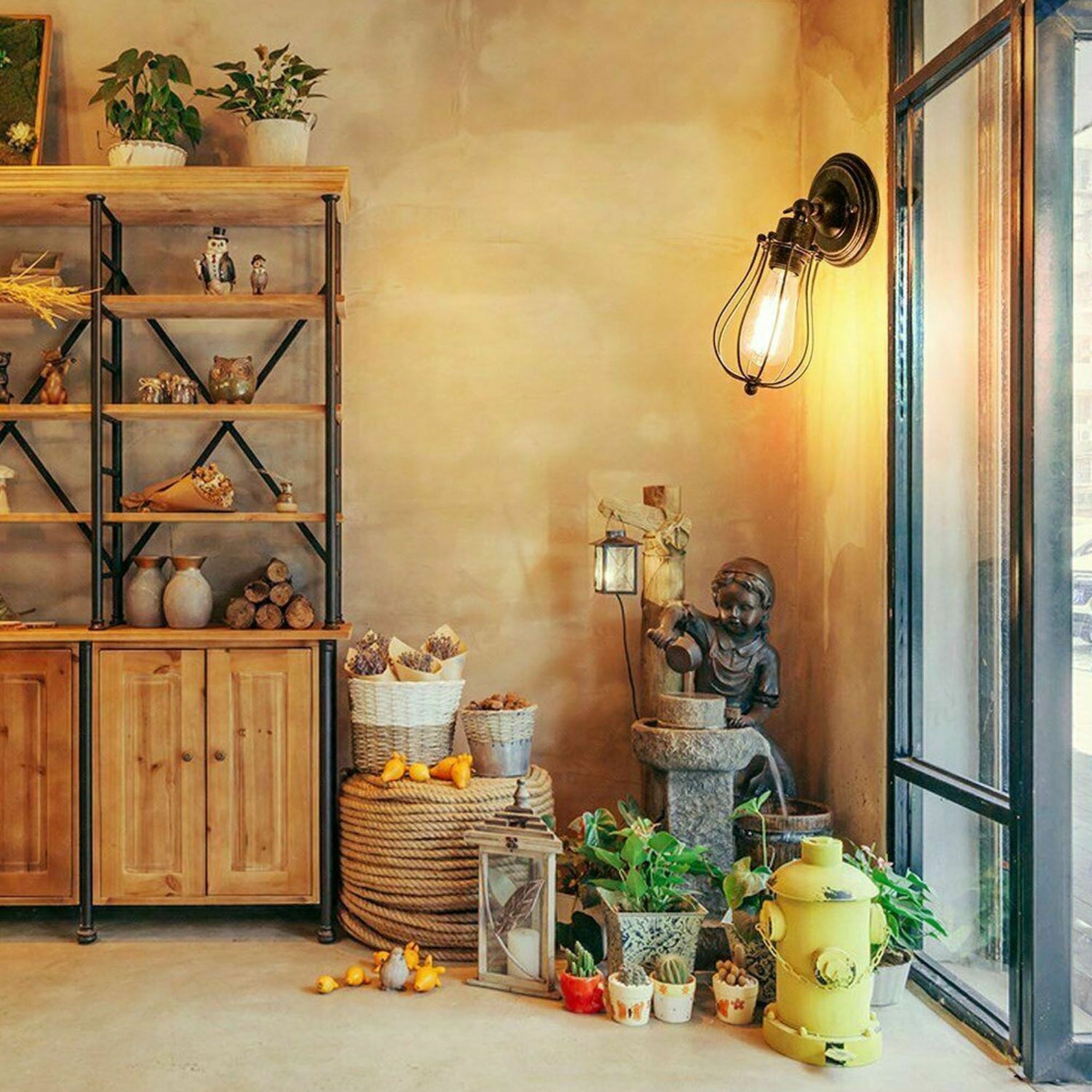 Industrial brushed silver balloon cage wall sconce lamp with a modern design, showcasing its elegant brushed finish and open cage structure.