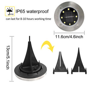 Four LED solar powered path lights in a garden setting, showcasing their waterproof and stainless steel design.