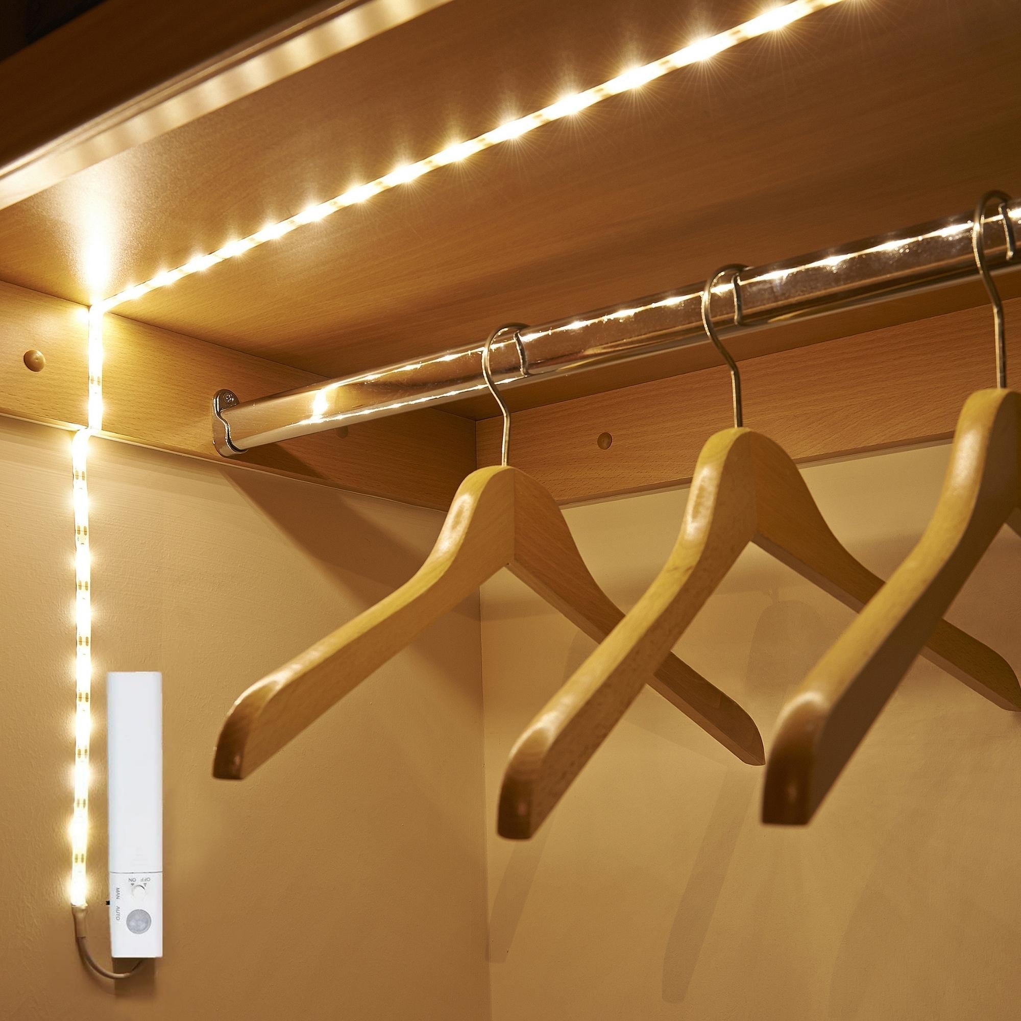 Motion Sensor LED Light Strips installed in a wardrobe, illuminating the interior with bright light.